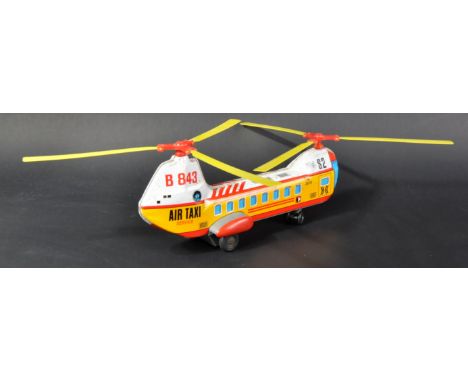 A vintage Japanese Haji made battery operated tinplate twin engine Air Taxi Service helicopter. Yellow plastic rotors with ti