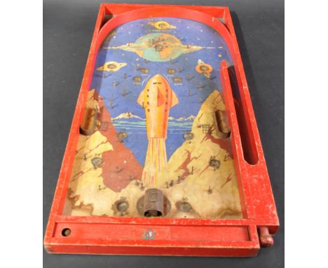 An early 20th Century Chad Valley bagatelle tabletop Space themed game.Wooden construction painted red with a space themed ba