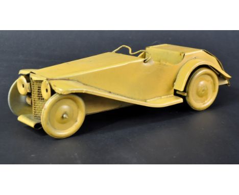 An original vintage early Burnett made tinplate / clockwork model sports car. Yellow painted bodywork with headlights and ste