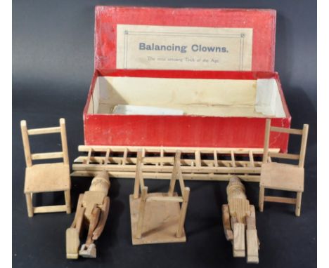 A 19th Century Victorian ' Balancing Clown ' game with wooden articulated clown figures, chairs and ladder for balancing. Hou