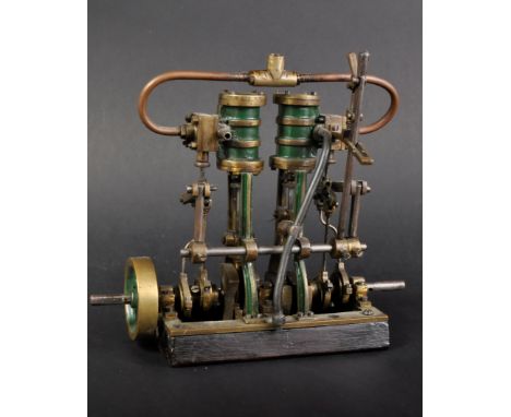 A vintage British Stuart Turner twin cylinder live steam model. Wooden box bed with brass plate, fly wheel and two twin breen