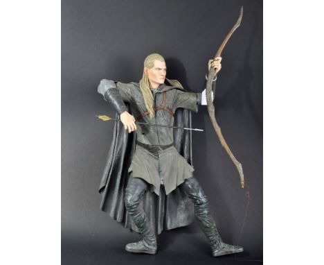 A large Neca made LOTR Lord Of The Rings Legolas action figure with Lorien bow, arrow and daggers in scabbards to the back.