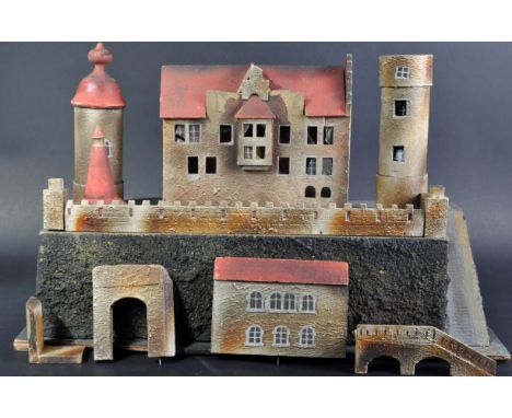 An early 20th Century German Heyde composition model castle with brick walls, bridges, turrets and towers.