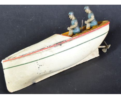 An early 20th Century circa 1910 tinplate clockwork model boat. White exterior with x2 passenger figures and rudder / propell