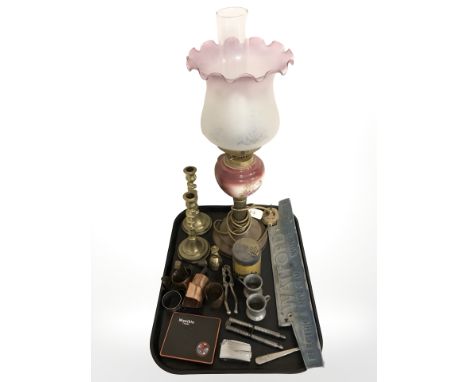 A ceramic and glass oil lamp, pair of brass barley twist candlesticks, Ronson lighter, nutcrackers, toffee hammer, die cast m