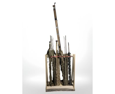 A rustic pine fishing rod stand containing 6 split cane rods in canvas slips including J. A. Walker of Alnwick example etc 