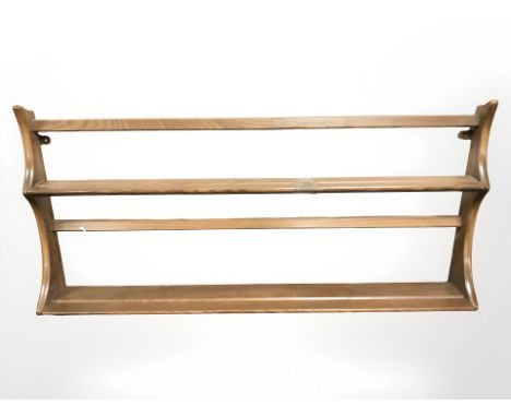 An Ercol stained elm plate rack, width 96 cm 