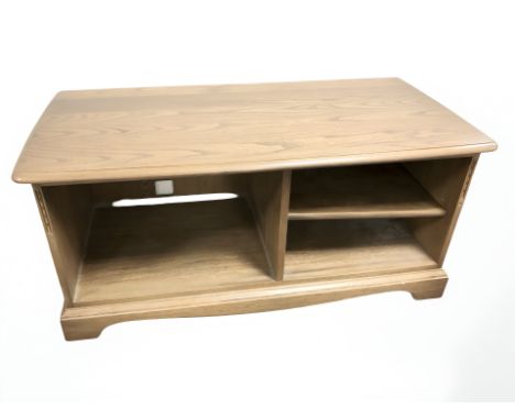 An Ercol elm entertainment unit, 111 cm x 52 cm x 50 cm.