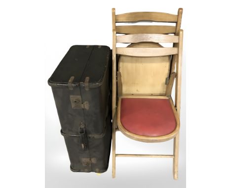 A pair of folding chairs and a luggage case 