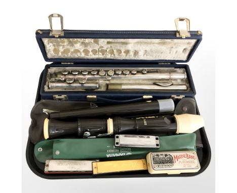 A Boosey & Hawkes emperor three piece chrome flute in box, an Aulos recorder and several harmonicas.