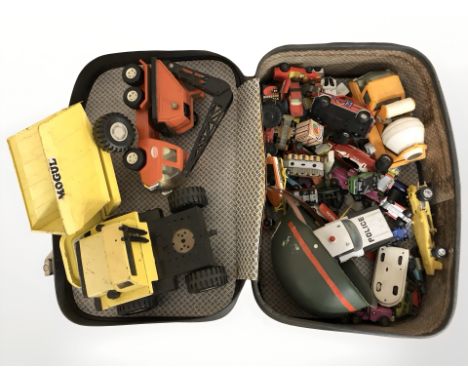 A suitcase containing die cast vehicles, excavators, cranes, etc, including Tonka, Corgi, etc. 