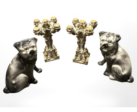 A pair of ornate resin candelabra and a pair of pottery fireside dog ornaments, height 22 cm.