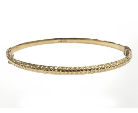 A 9ct yellow gold hollow bangle, internally 65 mm x 56 mm. CONDITION REPORT: 4.5g