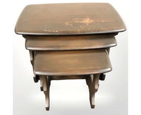 An Ercol stained elm nest of three tables, width 57 cm.