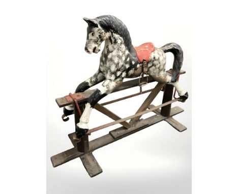 A 20th century painted composition rocking horse on stained pine stand, overall 145 cm long 