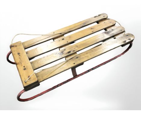 A vintage pine and metal sledge 