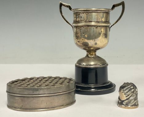 An Edwardian silver oval pot pourri or lavender box, 7cm wide, London 1906; a silver trophy, Birmingham 1929; a silver thimbl