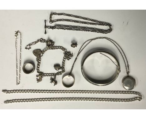 A silver curb link necklace, smaller bracelet, small silver double Albert chain, hunge bangle, silver and white metal charm b