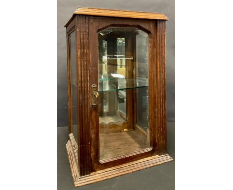 A late 19th century oak shaped rectangular table top display cabinet, mirrored back, three bevelled glass panels, single glas