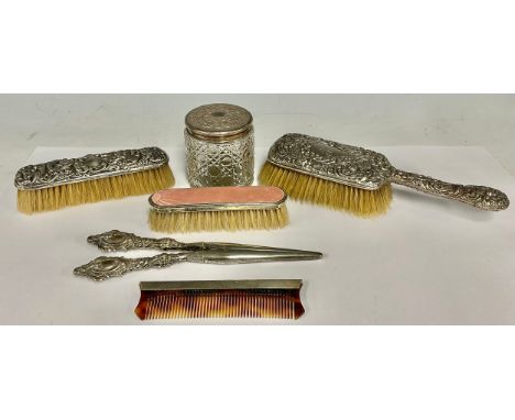 A Victorian silver dressing table brush, chased with cherubs amongst flowers and foliate scrolls, Chester 1899; other silver 