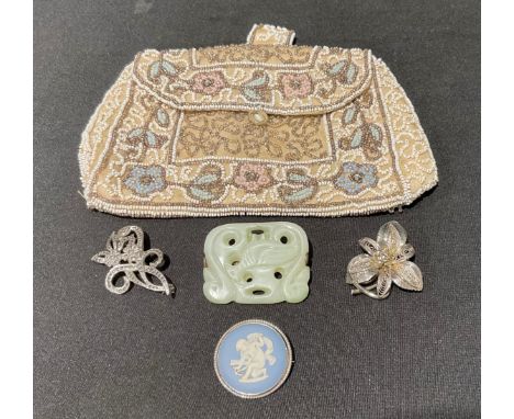 A Chinese carved apple green stone tablet brooch, possibly jade, as two swans cradling a bird, 4.6cm x 3.7cm;  Wedgwood jaspe