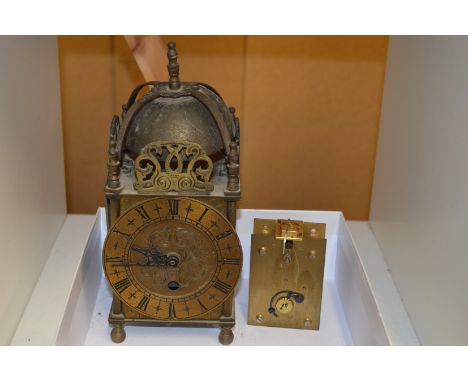 A reproduction brass lantern clock with quartz movement (original movement included).