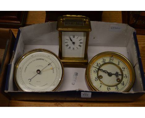 A brass carriage clock, a small circular clock and barometer.