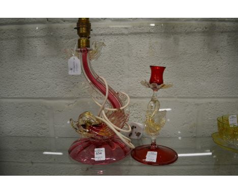 A Murano glass dolphin lamp and similar candlestick.