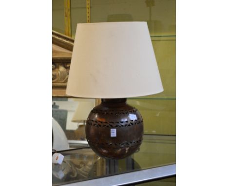 An eastern metal table lamp.