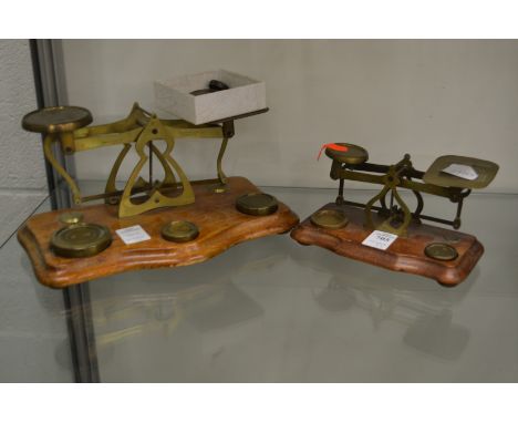 Two postal scales with various weights.