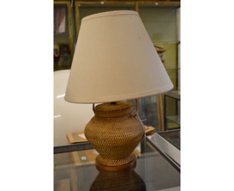A wickerwork table lamp.