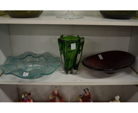 A heavy lobed green glass vase, a turquoise wavy rimmed dish and a ruby glass oval dish.