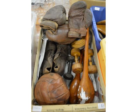 Old sporting equipment to include a pair of leather boxing gloves, football boots, football, rugby ball, discus, weights and 