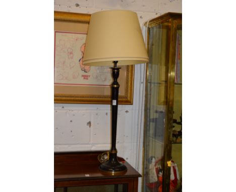A decorative candlestick style table lamp.