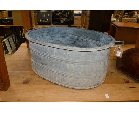 A large galvanized oval planter, a galvanized bath and a grain measure.