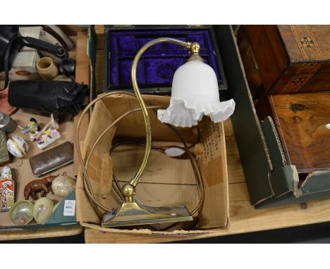 A brass desk lamp with opaque glass shades.