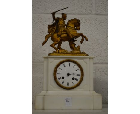 A Victorian marble mantle clock decorated with a knight on horseback.