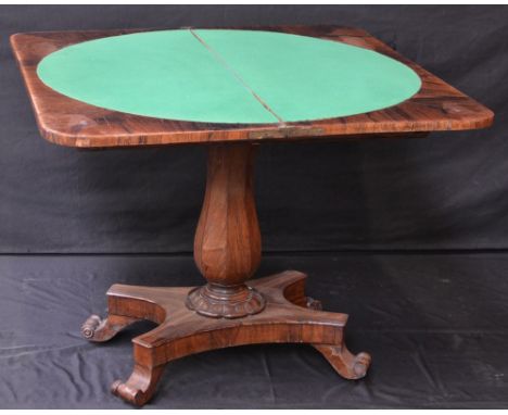 A Victorian rosewood card table, the top opening to circular baize playing surface 