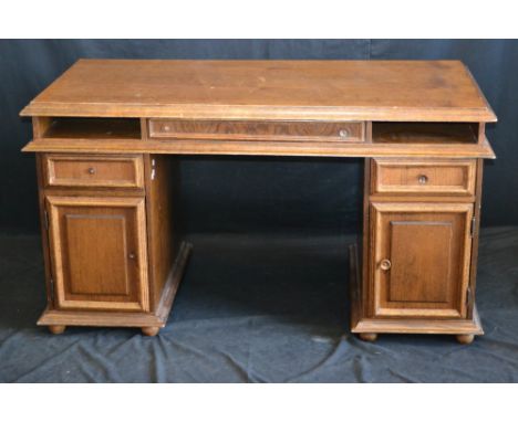 A reproduction oak twin pedestal desk