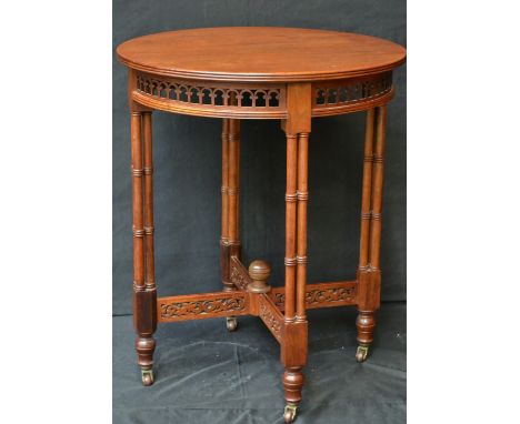 A Chippendale Revival walnut circular centre table, fretwork frieze, Gothic cluster-column legs, c.1910