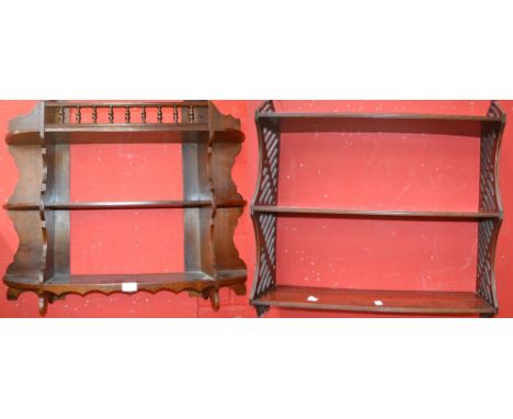 A mahogany wall shelf with fret cut decoration; an oak three tier wall shelf