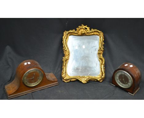 A Manthe chiming mantel clock; another, Smiths; a gilt framed mirror