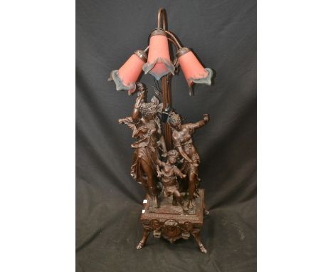 A large Art Nouveau style lamp, two female figures with child, three blown glass shades, approx. 103cm in height