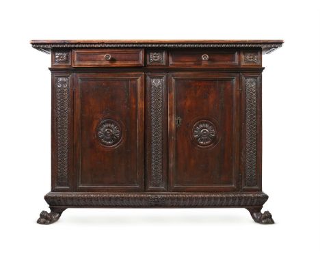 AN ITALIAN WALNUT SIDE CABINET LATE 16TH OR EARLY 17TH CENTURY  The doors opening to a shelved interior 123cm high, 170cm wid