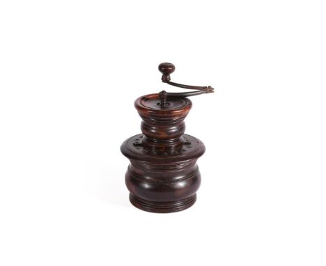A TURNED LIGNUM VITAE COFFEE GRINDER  18TH/19TH CENTURY  Folding iron turning handle above turned top, brass studded base 19.