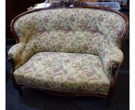 A Hepplewhite inspired mahogany framed sofa, bowed cresting rail applied with flowers and foliage, the apron conforming, serp