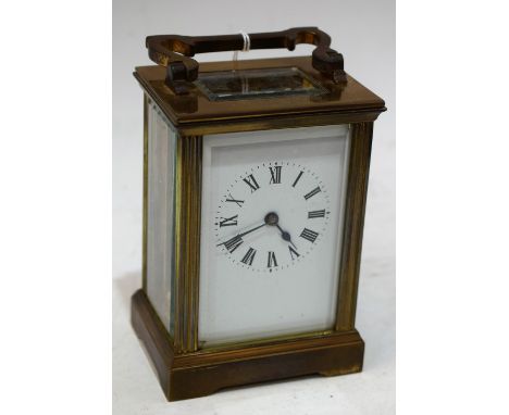 A 20th century brass carriage clock, white enamel dial, folding handle, 15cm high overall