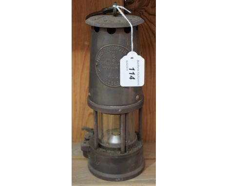 An Eccles Protector Lamp &amp; Lighting Co Ltd M &amp; G brass miner's safety lamp, 23cm high 