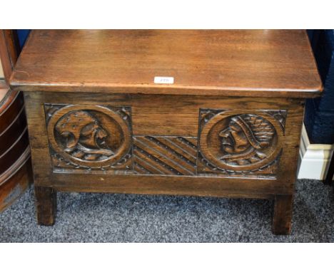 An oak blanket chest, of small proportions and carved with portrait roundels, mid-20th century