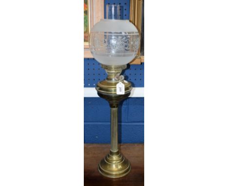 A early 20th century brass oil/paraffin lamp, floral globular shade and chimney, 69cm high overall